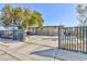 Charming single-story home featuring a gated front yard and spacious driveway at 2054 Harvard St, North Las Vegas, NV 89030