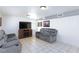 Comfortable living room showcasing neutral paint, a mounted television, and tile flooring at 2054 Harvard St, North Las Vegas, NV 89030