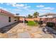 The backyard features desert landscaping and a covered patio at 206 Lynbrook St, Henderson, NV 89012