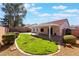 Backyard featuring a covered patio, grassy area, landscaping, and stone accents at 206 Lynbrook St, Henderson, NV 89012