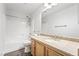 Bathroom with a granite vanity, new fixtures, and a shower and tub combo at 206 Lynbrook St, Henderson, NV 89012