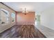 Dining room with wood-look flooring, chandelier, and large windows at 206 Lynbrook St, Henderson, NV 89012