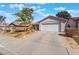 Beautiful single-story home showcasing a wide driveway and a well-manicured front yard at 206 Lynbrook St, Henderson, NV 89012