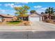 Charming single-story home featuring a well-maintained landscaped yard and a two-car garage at 206 Lynbrook St, Henderson, NV 89012