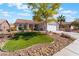 Inviting single-story home with a neat front yard, rock garden, and a comfortable sitting bench at 206 Lynbrook St, Henderson, NV 89012
