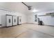 Garage with three cabinets and a light-colored floor with dark lines at 206 Lynbrook St, Henderson, NV 89012