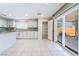 Bright kitchen with stainless steel appliances, granite counters, tile flooring, and direct access to the backyard at 206 Lynbrook St, Henderson, NV 89012