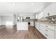 Bright, remodeled kitchen featuring white cabinetry, granite countertops, and stainless steel appliances in open space at 206 Lynbrook St, Henderson, NV 89012