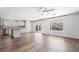 Open kitchen boasts white cabinets, stainless appliances, and island, seamlessly integrated into the living area at 206 Lynbrook St, Henderson, NV 89012