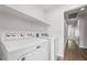 Bright laundry room with overhead shelves and modern appliances at 206 Lynbrook St, Henderson, NV 89012