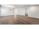 Open-concept living space with wood floors, seamlessly connecting to other rooms in a naturally lit setting at 206 Lynbrook St, Henderson, NV 89012