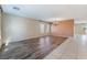 Open concept living room with wood-look flooring, light walls, and lots of natural light at 206 Lynbrook St, Henderson, NV 89012