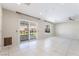 Bright living room boasts sliding glass doors and tile flooring at 206 Lynbrook St, Henderson, NV 89012