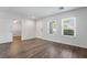 Inviting living room boasts wood flooring, white trim, and natural light, adjacent to an additional room at 206 Lynbrook St, Henderson, NV 89012