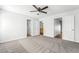 The main bedroom featuring neutral carpet, a ceiling fan, and a ensuite bathroom at 206 Lynbrook St, Henderson, NV 89012