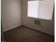 Cozy bedroom featuring carpet floors, and bright windows for a comfortable living space at 2108 E Ogden Ave, Las Vegas, NV 89101