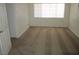 A bright bedroom featuring neutral carpet and a large window, creating a serene living space at 2108 E Ogden Ave, Las Vegas, NV 89101