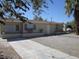 A single-story home with a gravel yard and mature trees in a sunny neighborhood at 2108 E Ogden Ave, Las Vegas, NV 89101