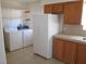 Bright kitchen features white appliances, tiled floors and wooden cabinets offering great functionality at 2108 E Ogden Ave, Las Vegas, NV 89101