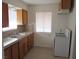 A clean kitchen featuring wooden cabinets, a white stove and a stainless steel sink at 2108 E Ogden Ave, Las Vegas, NV 89101