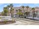 Inviting entrance to Sunrise Bay featuring mature palm trees and mountain views at 2110 Los Feliz St # 2064, Las Vegas, NV 89156
