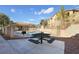 Community pool area with a barbecue grill and picnic table, perfect for outdoor entertaining at 2110 Los Feliz St # 2064, Las Vegas, NV 89156