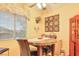 Inviting dining area with a round table, chairs, and natural light from the window at 2110 Los Feliz St # 2064, Las Vegas, NV 89156
