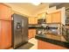 Well-lit kitchen features stainless steel appliances, light wood cabinets, and granite countertops at 2110 Los Feliz St # 2064, Las Vegas, NV 89156