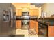Clean, organized kitchen featuring stainless steel appliances, wood cabinets, and granite counters at 2110 Los Feliz St # 2064, Las Vegas, NV 89156