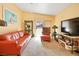 Bright living room with peach walls, neutral carpet, and sliding glass doors to the exterior at 2110 Los Feliz St # 2064, Las Vegas, NV 89156
