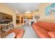 Open living room to kitchen, bright with peach walls, neutral carpet and stylish decorations at 2110 Los Feliz St # 2064, Las Vegas, NV 89156