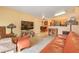Open living room to kitchen with light, peach walls, neutral carpet, and stylish decor at 2110 Los Feliz St # 2064, Las Vegas, NV 89156