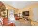 Open living room and mountain views from sliding door, with peach walls and neutral carpet at 2110 Los Feliz St # 2064, Las Vegas, NV 89156
