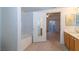 Bathroom showcases a white tub, a double sink vanity, and a door to another room at 2152 Turquoise Ridge St # 105, Las Vegas, NV 89117