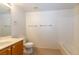 Bright bathroom with a single sink vanity, a toilet, and a bathtub with tiled surround at 2152 Turquoise Ridge St # 105, Las Vegas, NV 89117