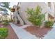 Exterior showing meticulously landscaped grounds, stairs leading to upper units, and mature trees at 2152 Turquoise Ridge St # 105, Las Vegas, NV 89117