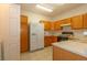 Functional kitchen with wooden cabinets and essential appliances, ready for culinary adventures at 2152 Turquoise Ridge St # 105, Las Vegas, NV 89117