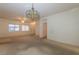 Open concept living space with a decorative light fixture and views of the entryway at 2152 Turquoise Ridge St # 105, Las Vegas, NV 89117