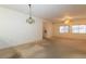 Comfortable living area showcasing neutral tones, carpet, and seamless flow to the kitchen at 2152 Turquoise Ridge St # 105, Las Vegas, NV 89117