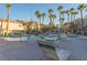 Resort style community pool with seating, palm trees, and waterfall feature for relaxing summer days at 2152 Turquoise Ridge St # 105, Las Vegas, NV 89117
