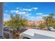 Balcony view overlooking green trees, tropical palm trees, and covered parking at 2201 Ramsgate Dr # 823, Henderson, NV 89074