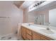 Bathroom featuring a double sink vanity with a large mirror and a separate glass-enclosed shower at 2201 Ramsgate Dr # 823, Henderson, NV 89074