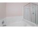 Bathroom showcasing a tiled tub with a glass-enclosed shower at 2201 Ramsgate Dr # 823, Henderson, NV 89074
