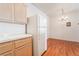 Bright kitchen area featuring wooden cabinets, white appliances, and wood-look floors at 2201 Ramsgate Dr # 823, Henderson, NV 89074