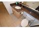 Bathroom featuring a double sink vanity with granite countertops and a neutral-toned tiled floor at 230 E Flamingo Rd # 229, Las Vegas, NV 89169