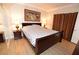 Comfortable bedroom featuring a queen bed, two side tables and wood laminate flooring at 230 E Flamingo Rd # 229, Las Vegas, NV 89169