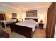 Comfortable bedroom with mirrored closet doors, a queen-sized bed, and side tables at 230 E Flamingo Rd # 229, Las Vegas, NV 89169