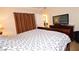 Cozy bedroom with a queen-sized bed and an entertainment center at 230 E Flamingo Rd # 229, Las Vegas, NV 89169