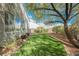 Backyard with well-manicured artificial turf and mature landscaping offers a serene and low-maintenance outdoor retreat at 2306 Valley Cottage Ave, Henderson, NV 89052