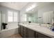 Bright bathroom with a soaking tub, separate shower, and double sink vanity at 2306 Valley Cottage Ave, Henderson, NV 89052